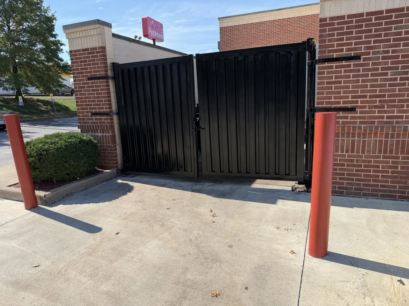 Commercial dumpster enclosure gates refinished in gloss black